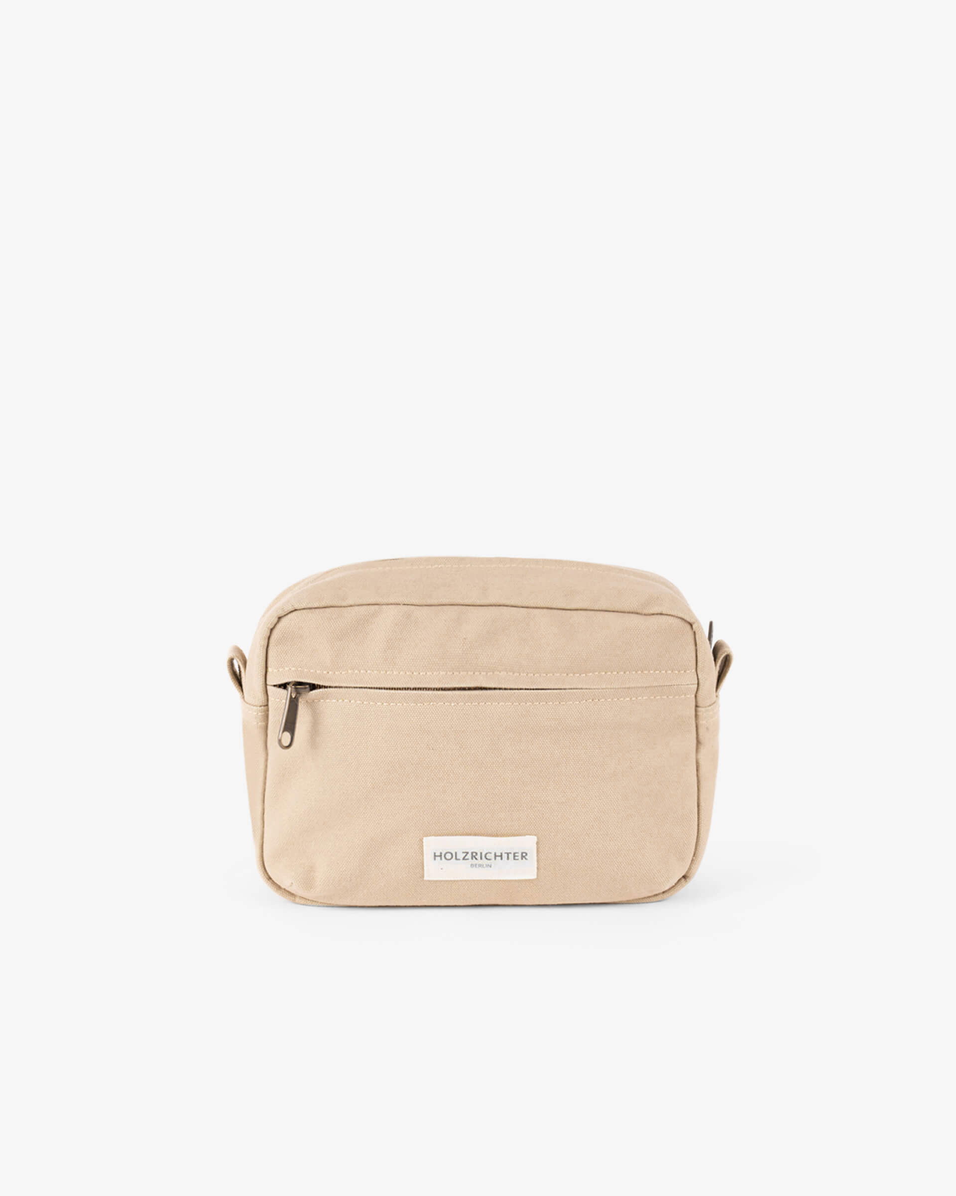 Elegante Crossbody-Tasche in sandfarben mit Überschlag, Schnallenverschluss und verstellbarem Schulterriemen.